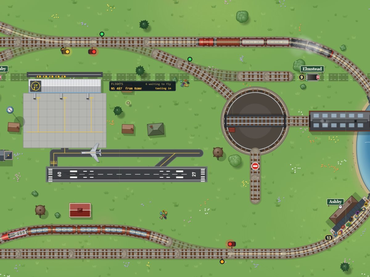 LocoSim - a model railway with a turntable, a station by a lake and an airport, seen from above