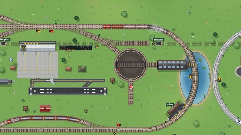 A turntable and engine shed beside a lake, an airport runway with a jet, and a diesel goods train on the main line